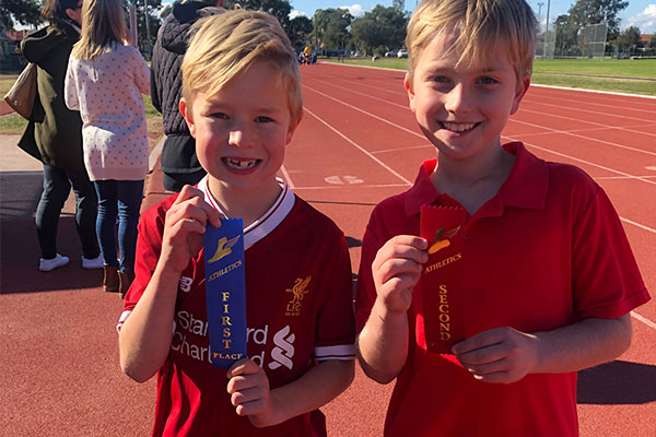 St Agnes Catholic Primary School Matraville students showcasing their ribbons in athletics